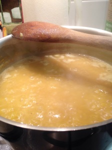 Red lentils on a rolling boil in pot for Tarka dhal